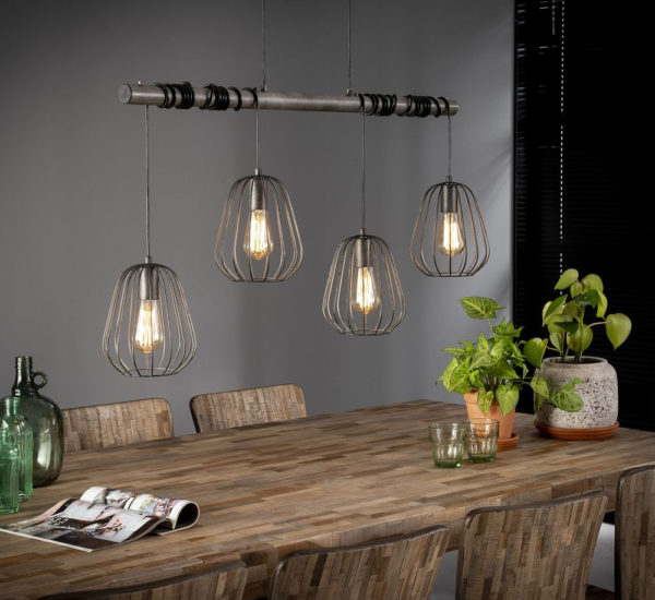 Zu sehen ist eine Lampenhalterung mit 4 Lampen daran die umgeben sind von einem Vasen förmigen Gitter und diese hängen über einen hölzernen Esstisch.
